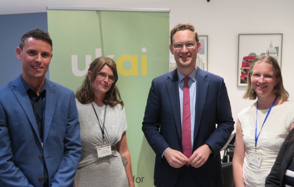 Darren Jones MP stands in front of a UKAI banner at an event with 3 people from NCC and BriCS